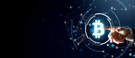Businessman touching glowing Bitcoin symbol with digital network connections on dark background. Cryptocurrency and blockchain technology concept.