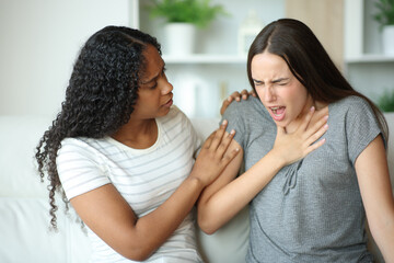 Black woman helping a friend suffering chest ache
