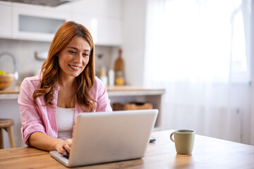 Beautiful woman freelancer noting information for planning project doing remote job via laptop computer. woman reading email on modern laptop device