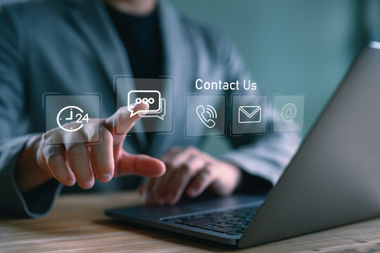 Contact us and virtual customer service. A person touch on virtual screen with modern contact icons, including chatbot, message, email, and call options, representing business support solutions.