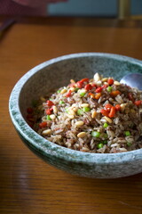 fried rice with vegetables in a stone bowl