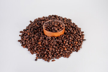 Bowl of ground coffee and beans isolated on white background.