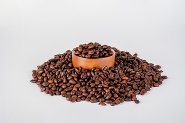 Bowl of ground coffee and beans isolated on white background.