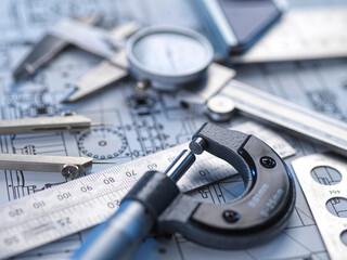 Close-up of engineering tools and blueprints for precision measurement and quality control