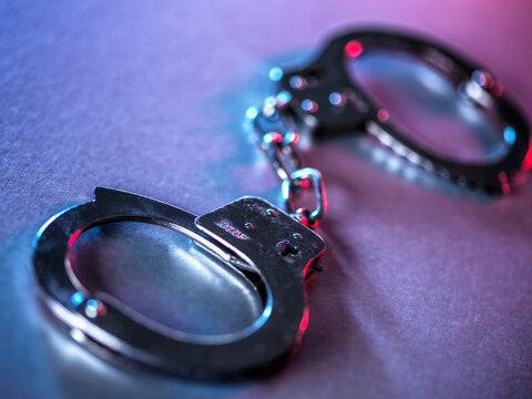 Close-up of metal handcuffs symbolizing justice and crime control