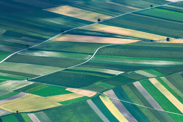 Aerial view of patchwork farmland with road layout in a rural landscape
