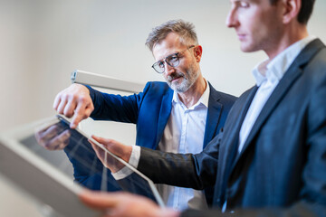 Business professionals discussing photovoltaic panels in an office setting