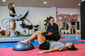 Women training in a gym focusing on Olympic judo and physical fitness