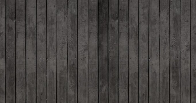 Weathered Black Wooden Fance Loop. Old Rough Wooden Wall Painted Black With Visible Wood Structure And Rings. Black Wooden Boards Arranged Vertically. Close up. 