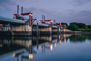 Evening view of Sperrwerk Billwerder Bucht in Hamburg, Germany with reflections on the water