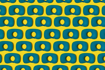Pattern of blue inflatable travel pillows on a yellow background