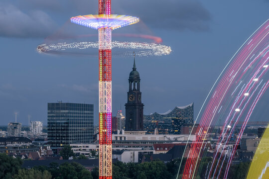 Aerial view of Hamburg with Church St. Michaelis and Elbphilharmonie in the background and a carousel in the foreground