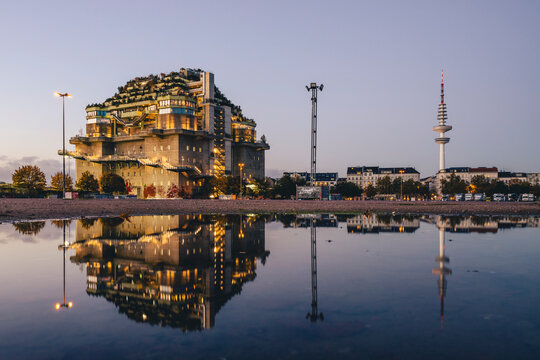 Green bunker at Feldstra�e in Hamburg reflecting in a puddle during evening
