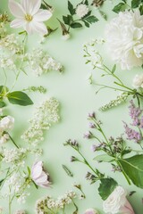 Fototapeta premium Fresh floral arrangement, delicate blooms on mint background, spring vitality, Motherâ€™s Day, natural beauty, vibrant petals, seasonal decor, eco-friendly design.