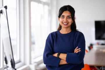 Confident woman smiling in a modern office setting