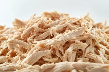 Close-up of shredded chicken on a white background.