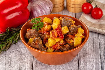 Rogiut with meat, potato and tomatoes