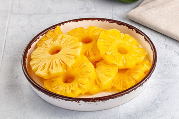 Sweet canned pineapple slices in syrope