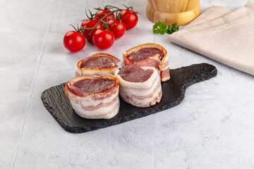 Raw pork tenferloin with bacon