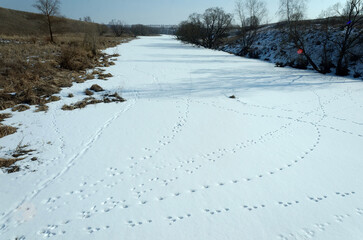 A small river under the ice on a clear day