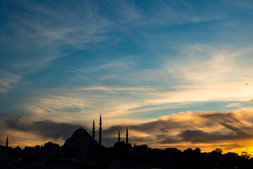 Ramadan or islamic concept photo. Silhouette of mosque at sunset with hazy sky