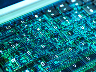 Futuristic view of a laptop keyboard with digital circuit overlay representing artificial intelligence and cybersecurity