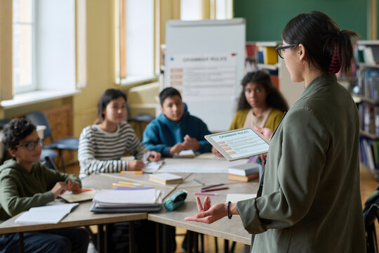 Woman teaching language class to intercultural group