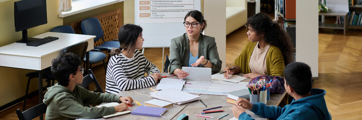 Teacher leading a study session with students in a classroom