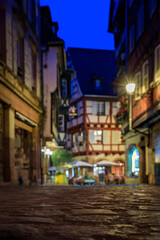 Blurred view of half timbered houses and cobblestones in Colmar, Alsace, France