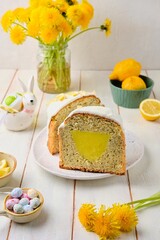 Making lemon cake or Easter cake with sugar icing on white wooden background. Easter food, baking.