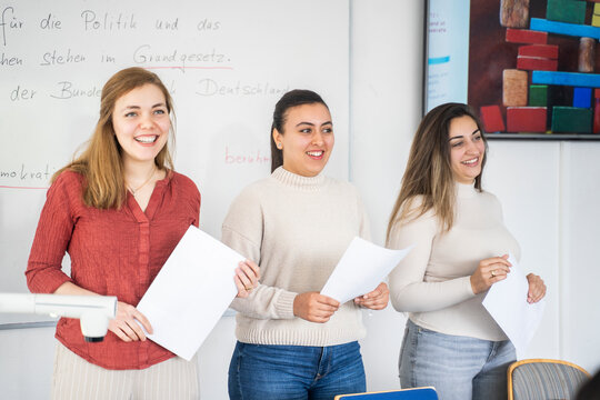 Students presenting a project in a multicultural classroom