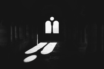 Sun shining through the window in a church. Black and white