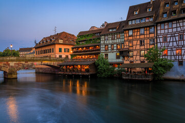 Obraz premium Half timbered houses by canals of Petite France in Strasbourg, France at sunset