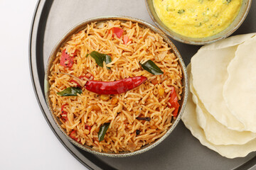 Tomato rice. spicy South Indian rice recipe Tomato pulao or Tomato Rice ,South India Thakkali  Sadam ,Tomato Bath an Indian vegetarian dish. with pumpkin raita Healthy nutritious
