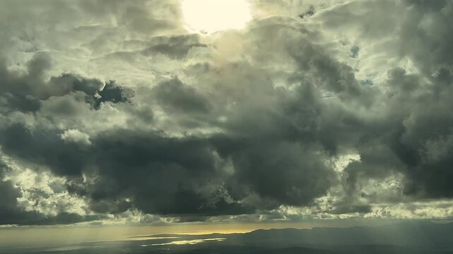 An immersive view of a stormy sky through the pilot&rsquo;s eyes while flying in sunset light, with a shining sun above. 4K