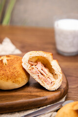 Whole wheat baked round bread on wooden table, warm tone atmosphere