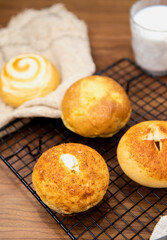 Whole wheat baked round bread on wooden table, warm tone atmosphere