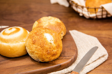 Whole wheat baked round bread on wooden table, warm tone atmosphere
