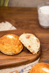 Whole wheat baked round bread on wooden table, warm tone atmosphere