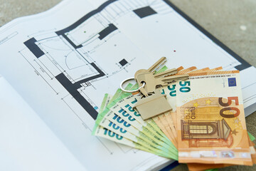 House keys and euro banknotes on architectural blueprint, real estate investment. Concept of home buying, renovation budget or mortgage planning