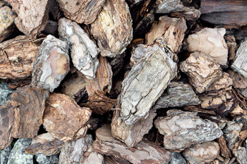 Close-up of natural back mulch. Organic material used for landscaping, soil protection, moisture...