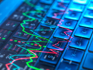 Stock market graph overlay on a computer keyboard representing financial data and investing