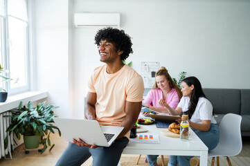 Young people working and studying together in a home office setting