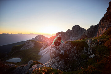 Woman climbing mountain ridge at Axamer Lizum, Austria
