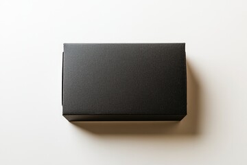 Blank black cardboard box on white surface