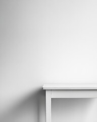 Obraz premium Minimalist white table against a white wall creating a clean and simple backdrop perfect for product photography and design mockups with ample copy space