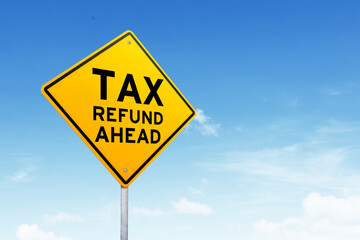 Tax refund road sign shot over beautiful blue sky.