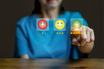 Close up woman hand show the smile face emoticon on the virtual touch screen ,give five star symbol, Customer service and business satisfaction survey.