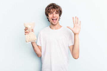 smiling cheerful showing number five with fingers.