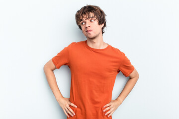 Young caucasian man isolated on blue background dreaming of achieving goals and purposes